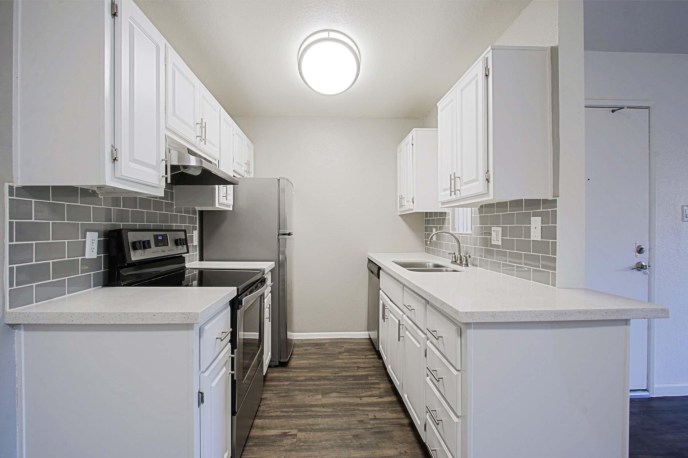 a kitchen with a stove and a refrigerator