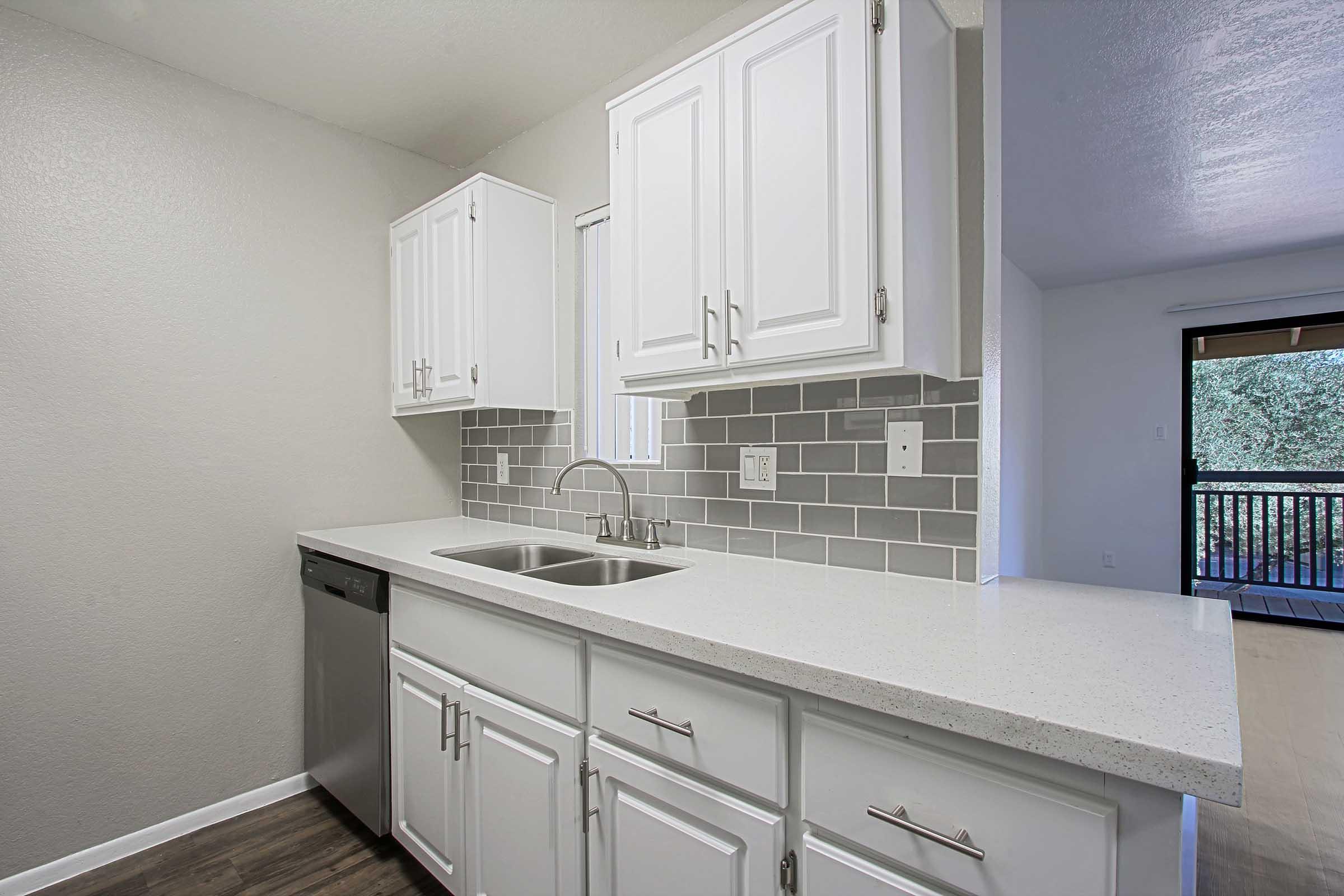 a kitchen with a sink and a window