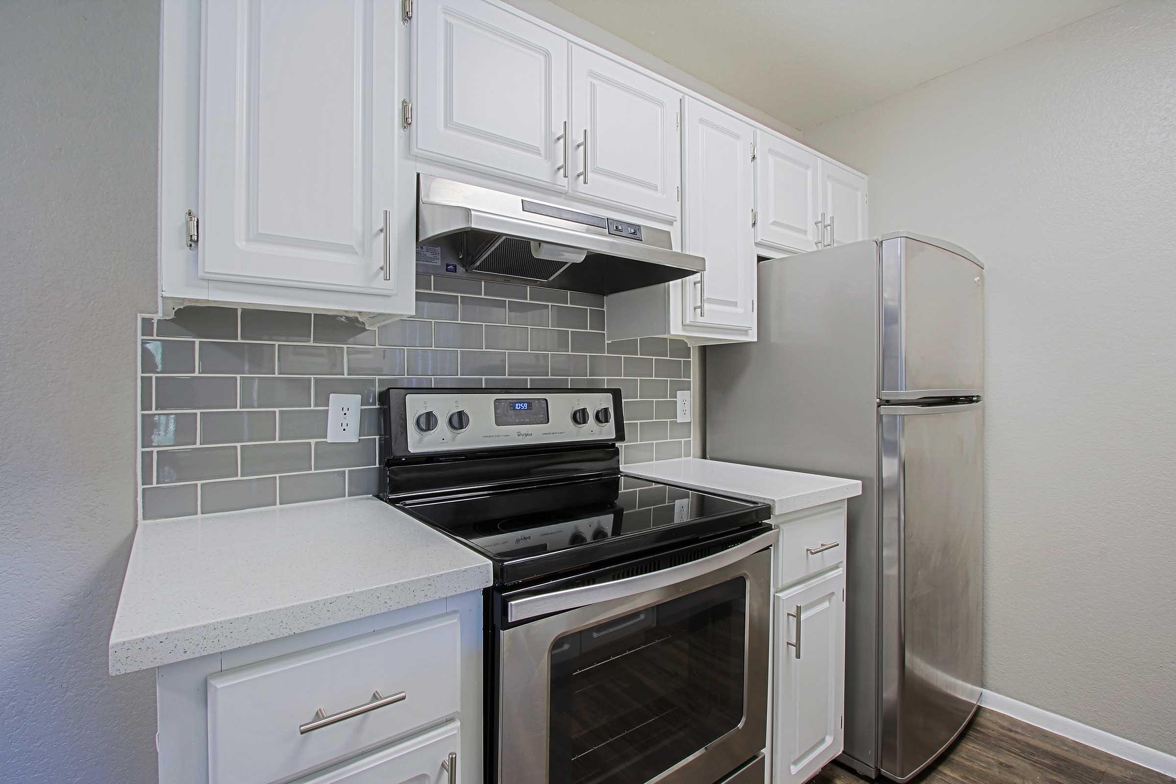 a stove top oven sitting inside of a kitchen