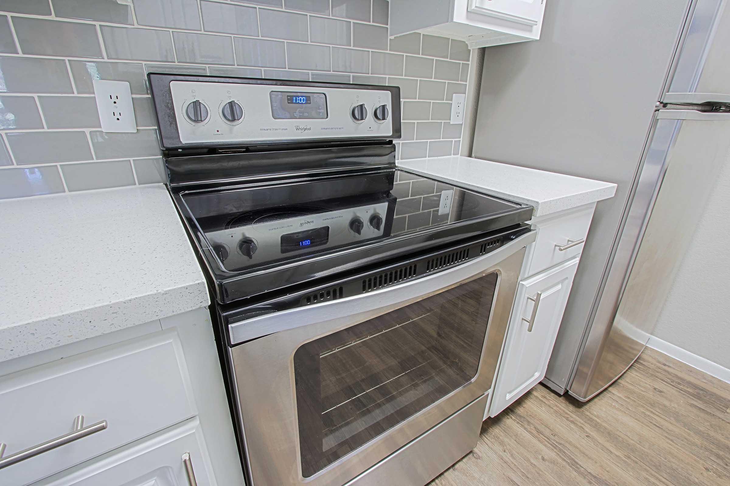 a stove top oven sitting inside of a kitchen