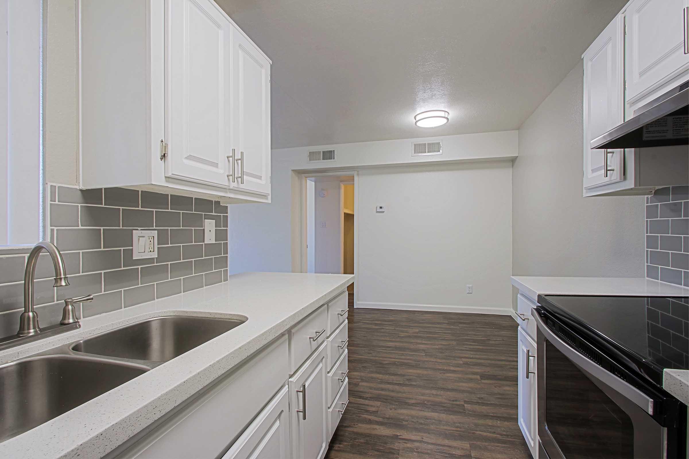 a kitchen with a sink and a window