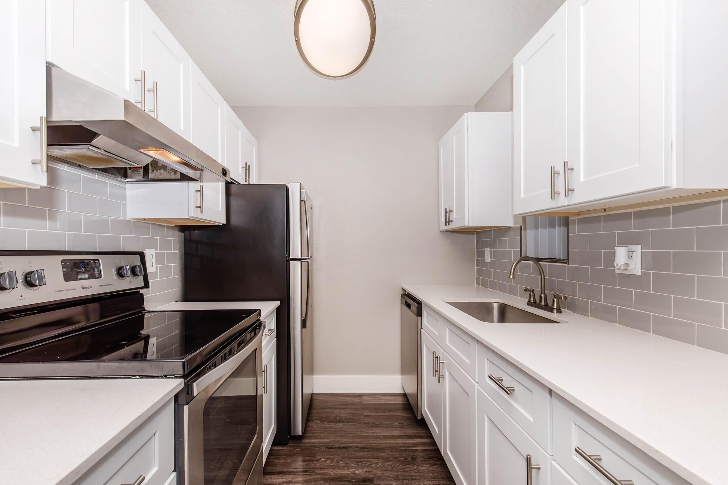 a kitchen with a stove and a sink