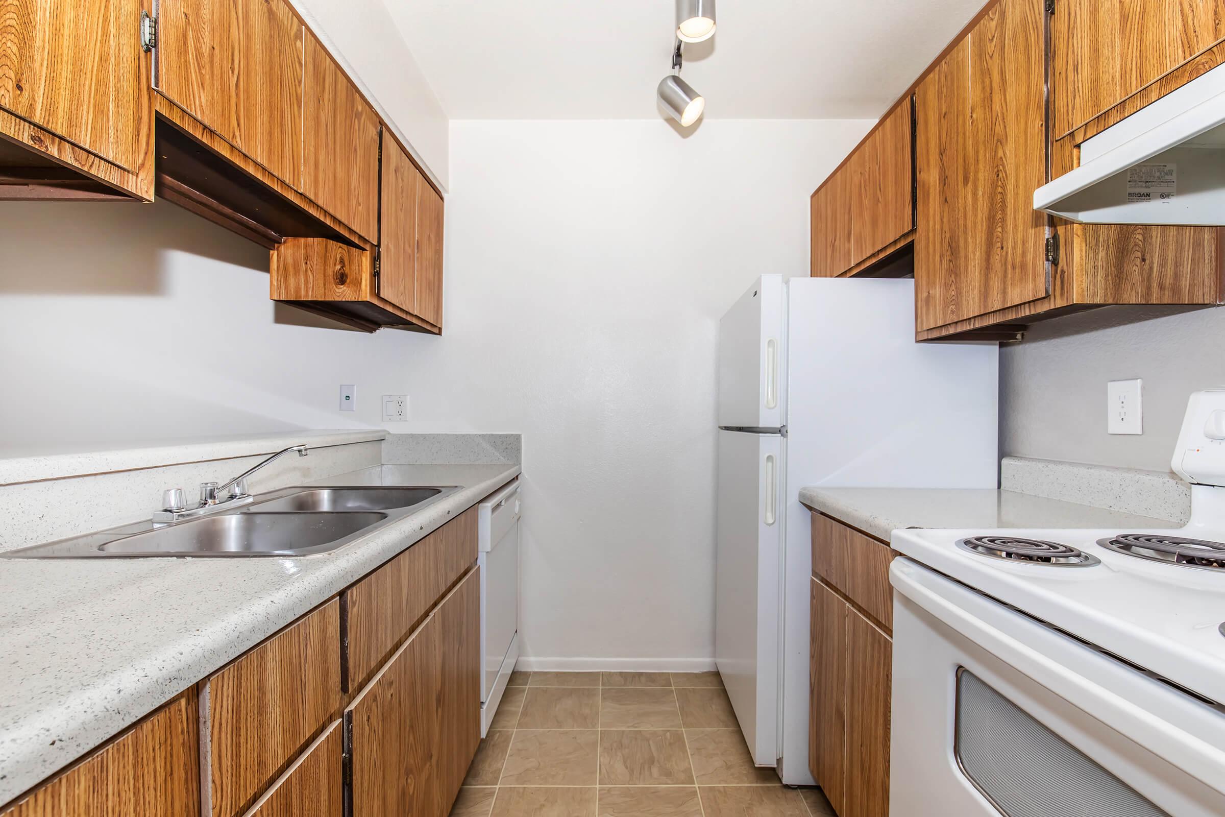 a kitchen with a stove sink and refrigerator