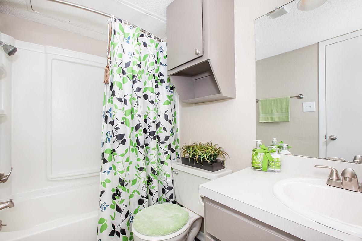 a white tub sitting next to a sink