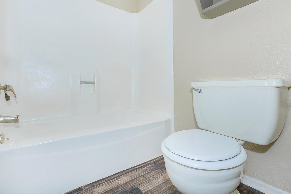 a white tub sitting next to a sink