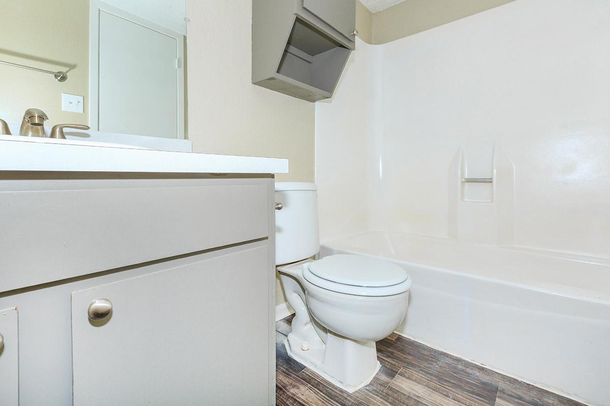 a white sink sitting next to a shower