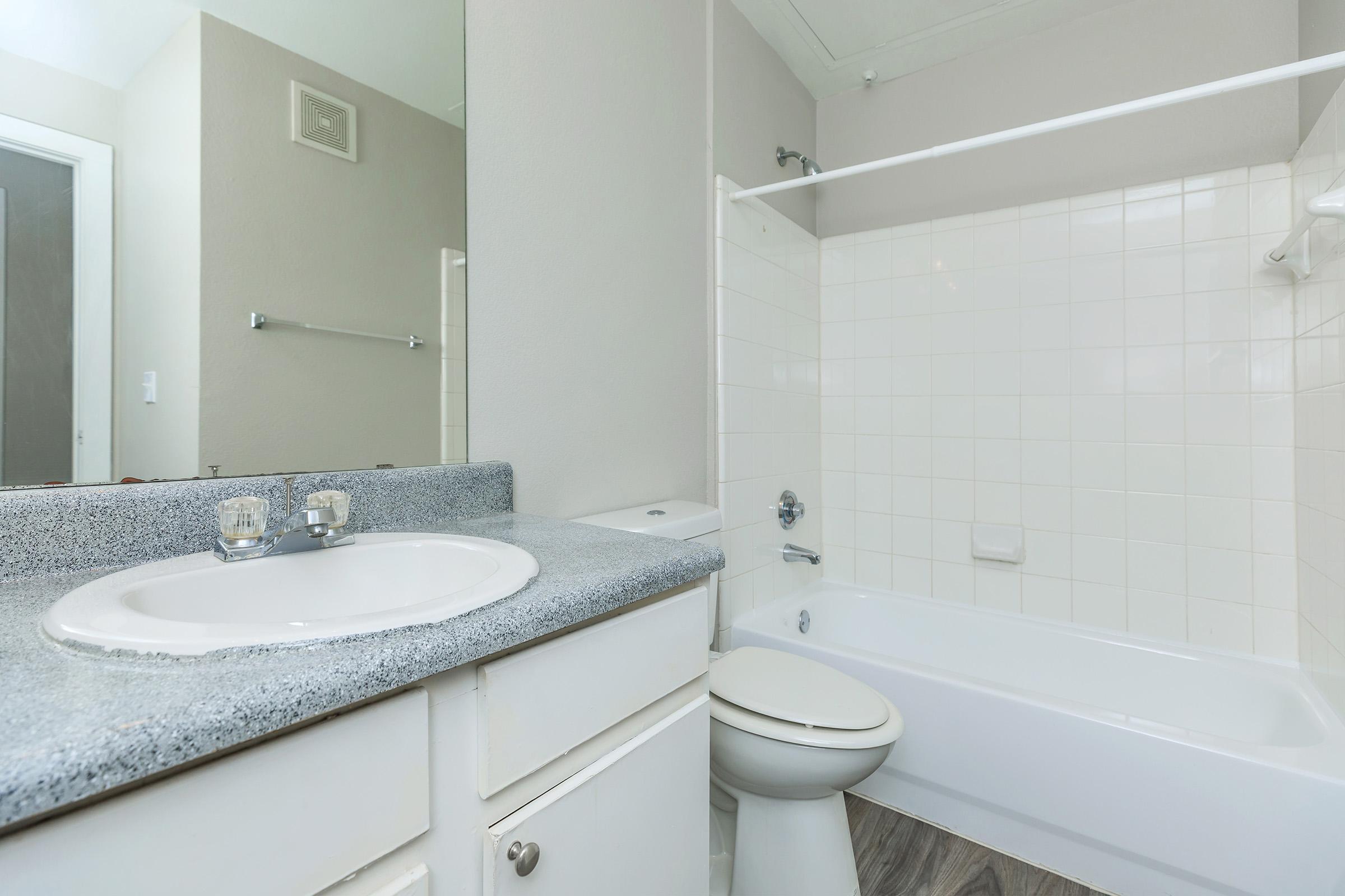 a room with a sink and a mirror