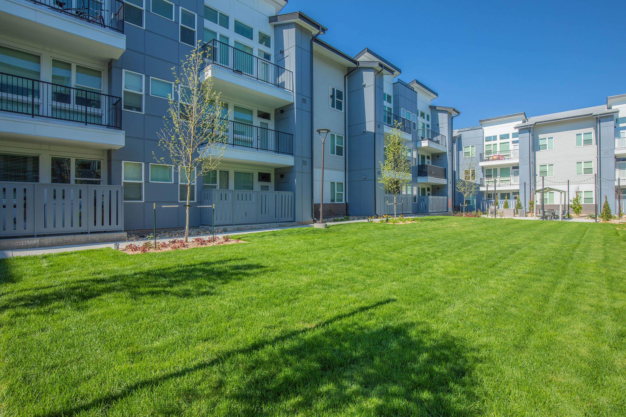 a large building with a grassy field