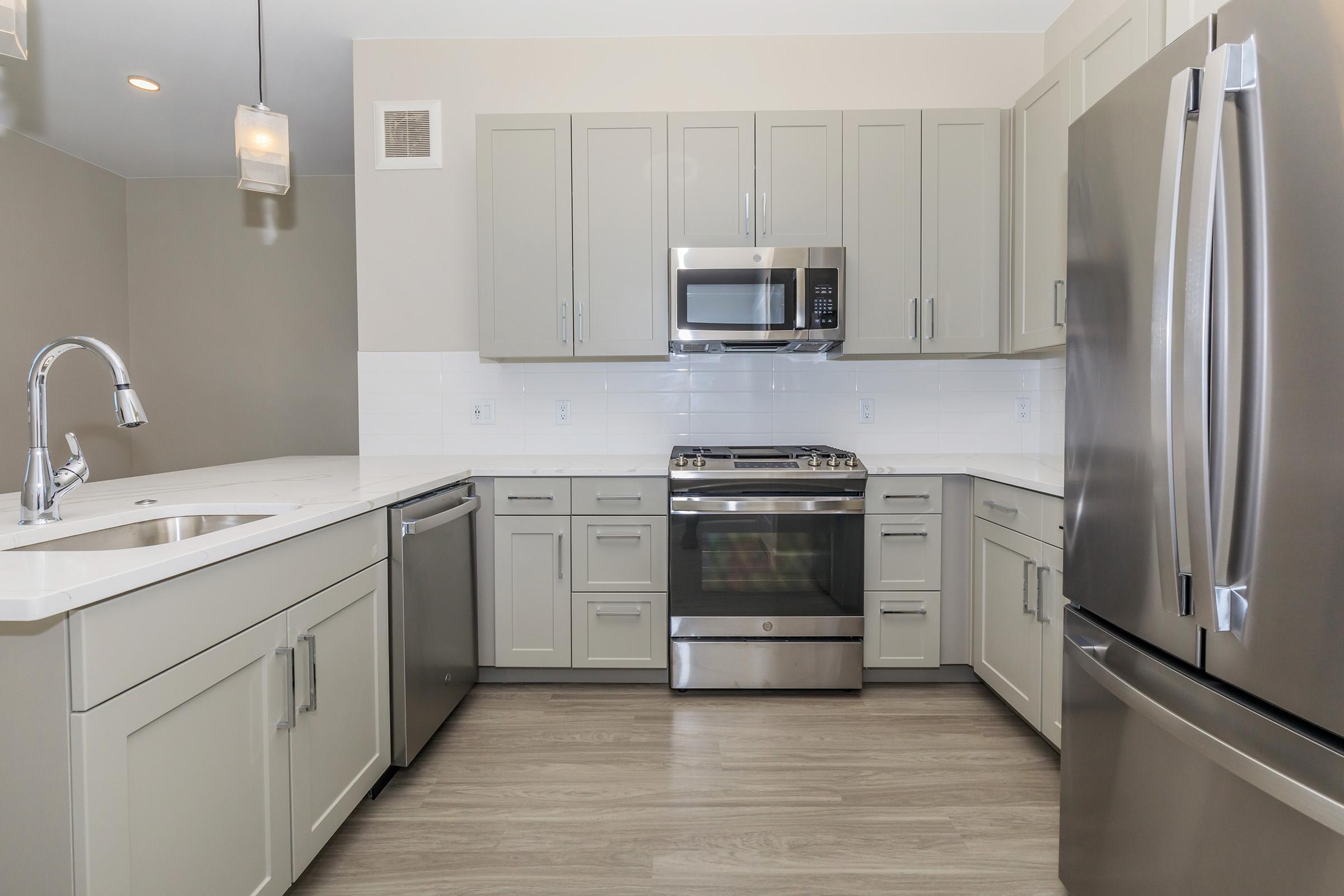 a kitchen with a sink and a refrigerator