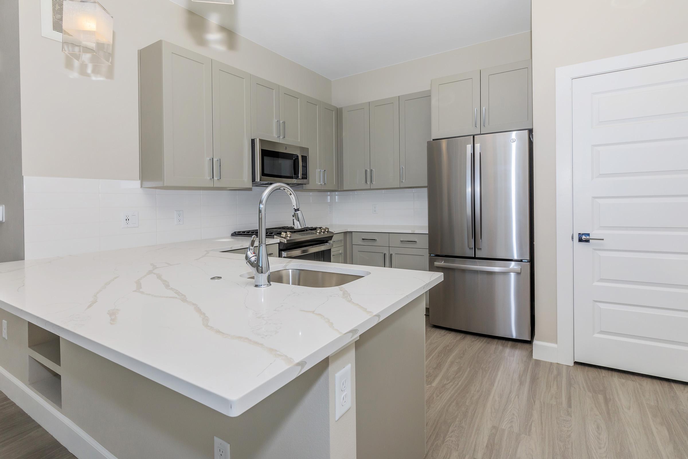 a kitchen with a sink and a mirror