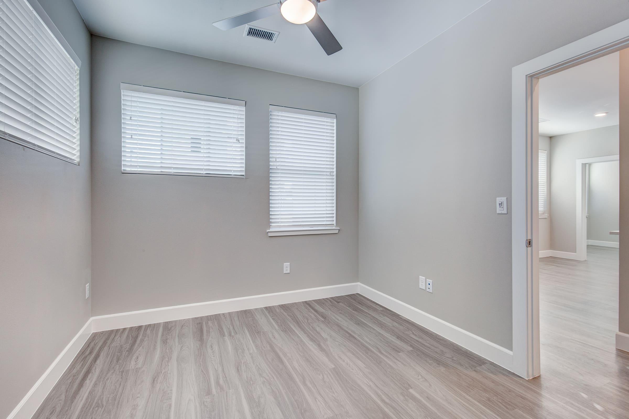 a large empty room with a sink and a window