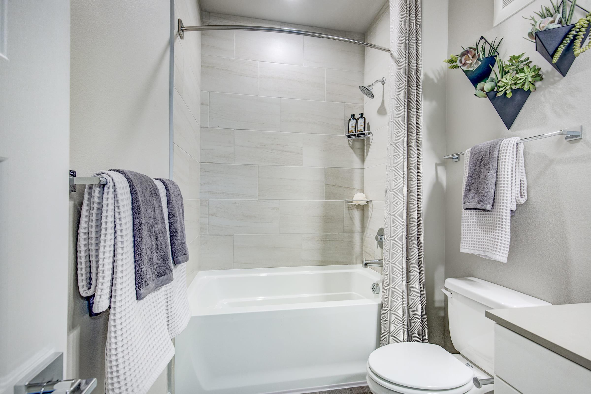 a shower with a towel hanging on the wall