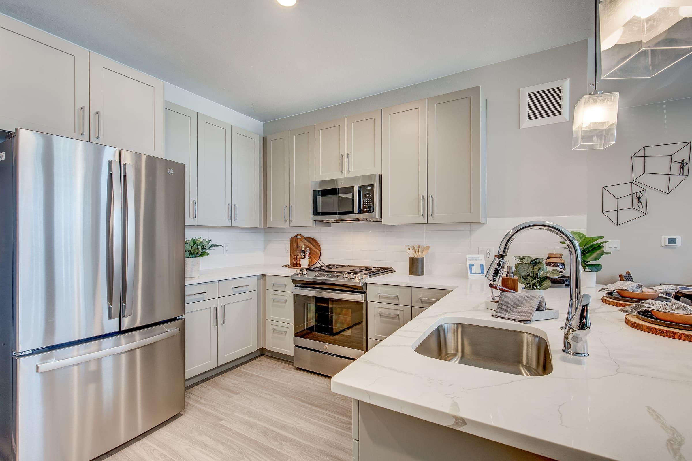 a kitchen with a stove sink and refrigerator