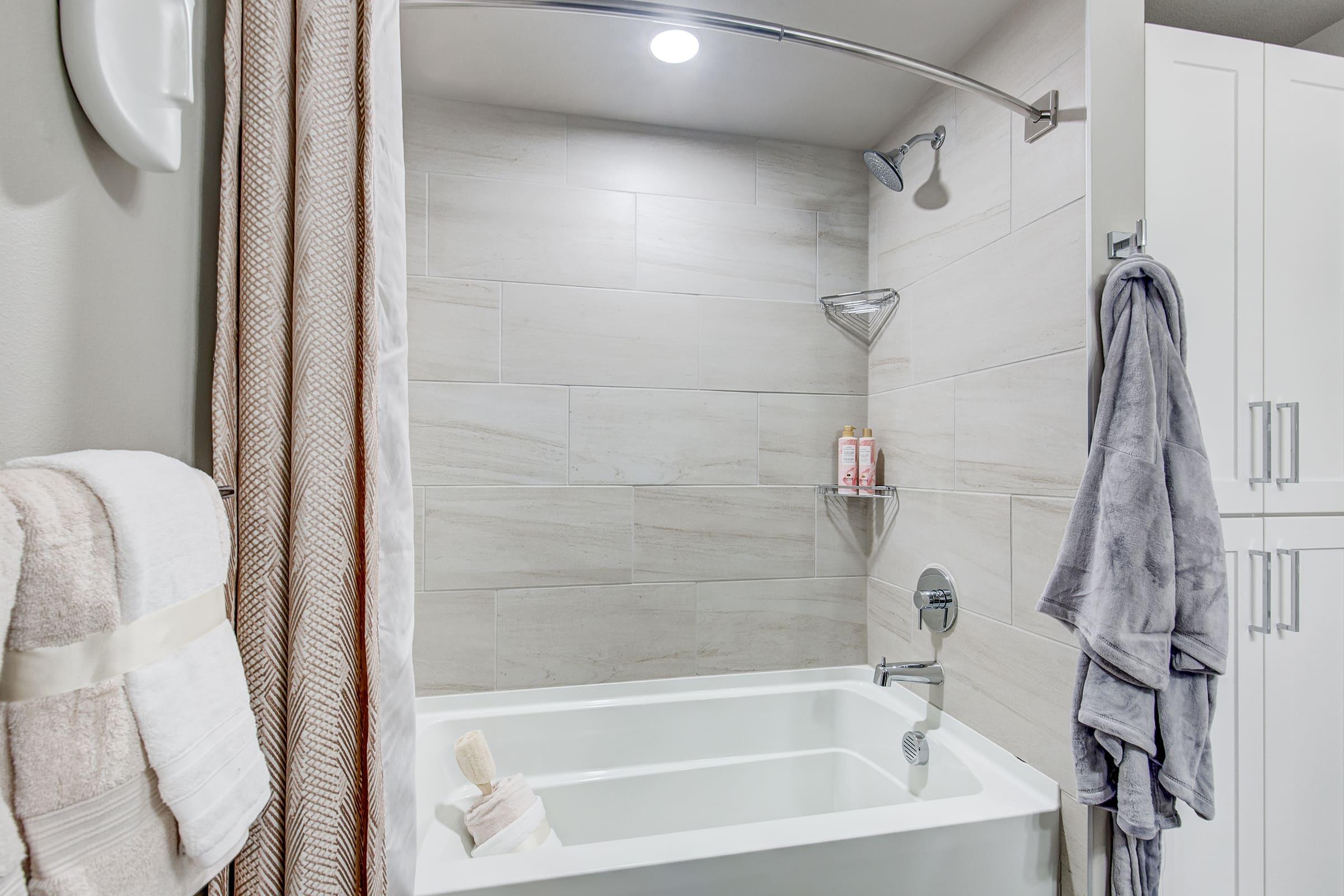 a shower with a towel hanging on the wall