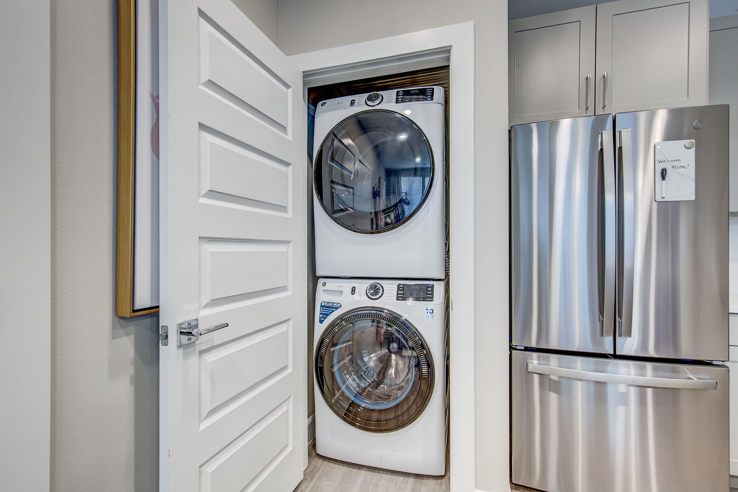 a kitchen with a clock at the top of a refrigerator