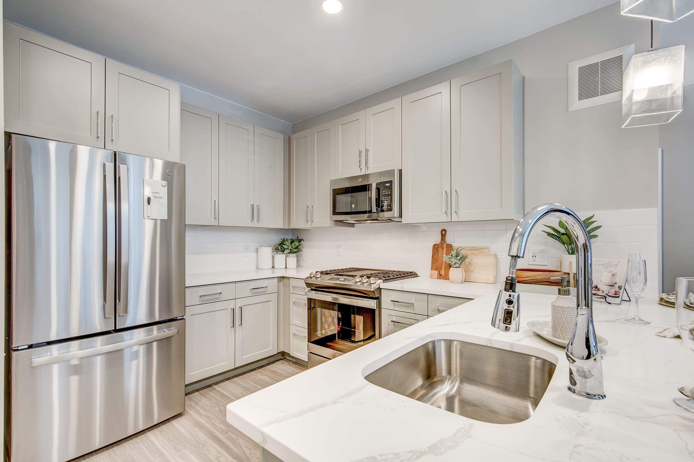 a kitchen with a sink and a refrigerator