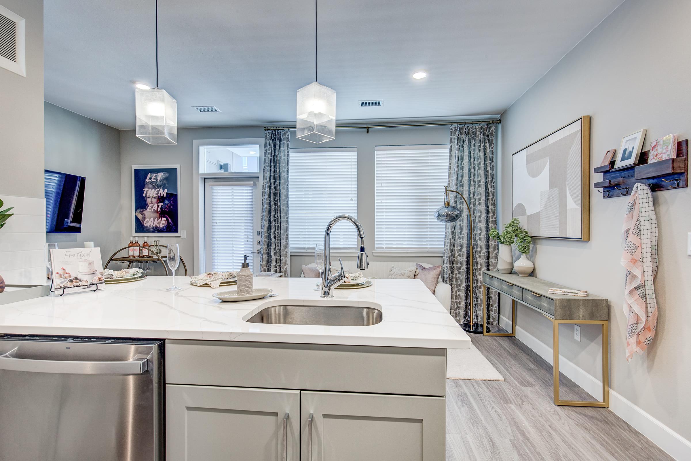 a kitchen with a sink and a mirror