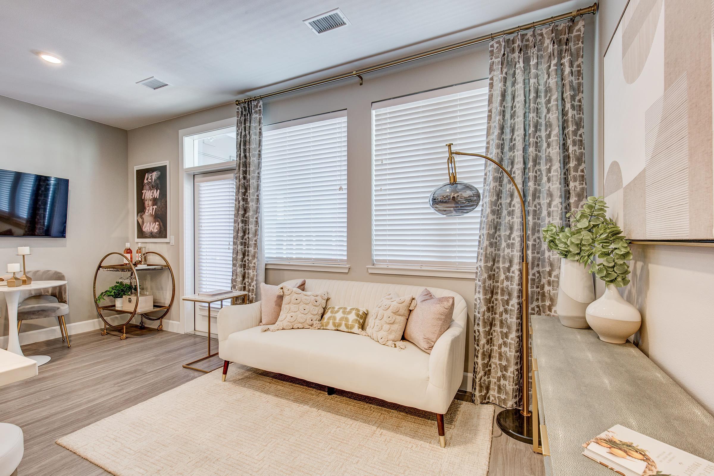 a living room filled with furniture and a large window