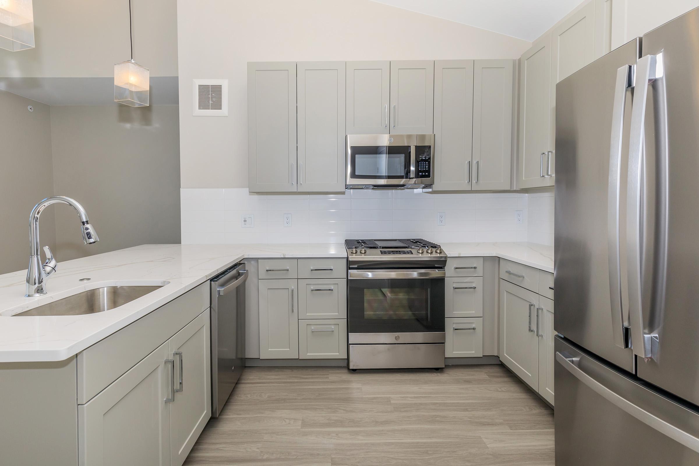 a kitchen with a sink and a refrigerator