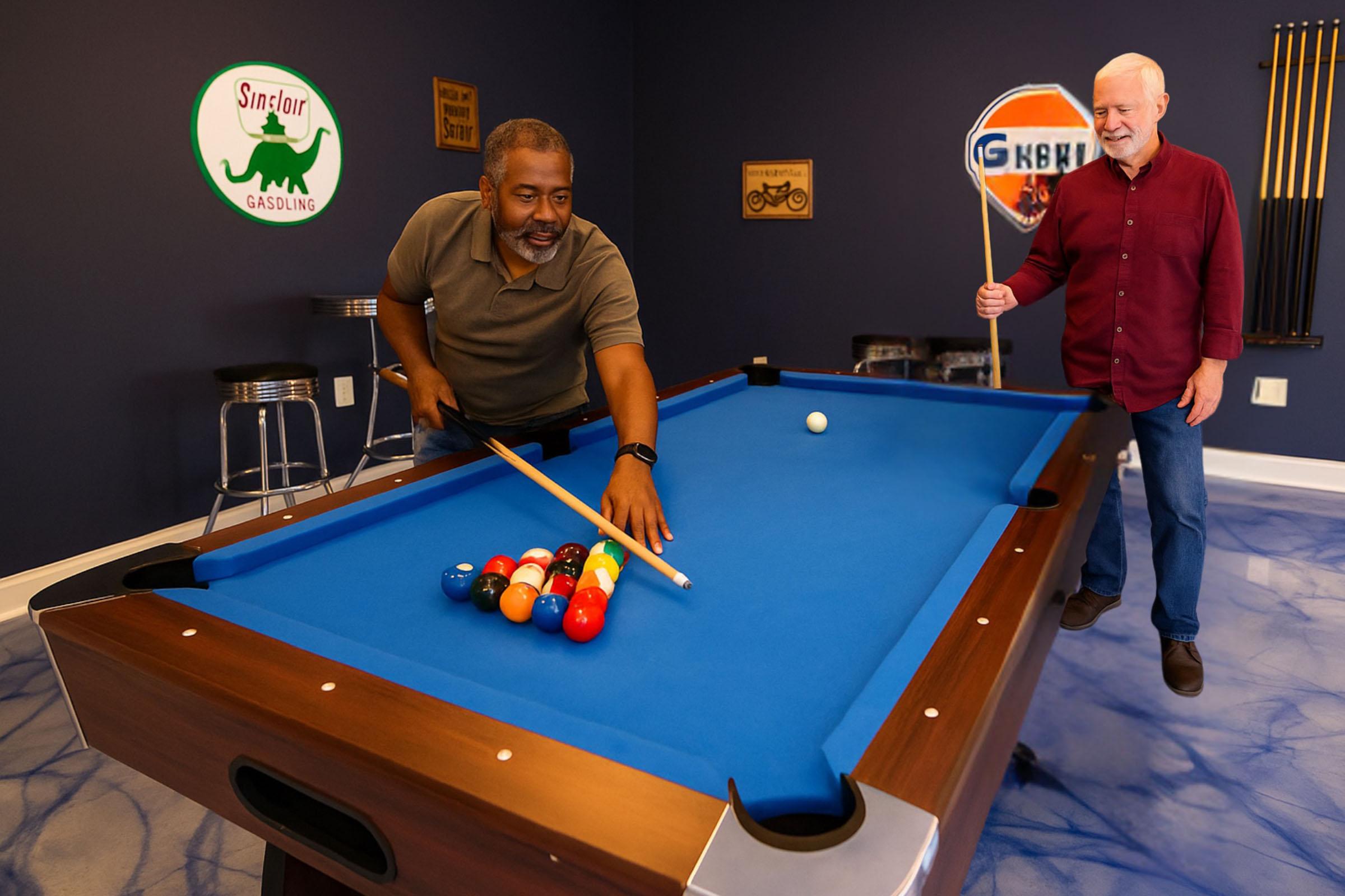 Two men playing pool in a game room. One man is bending over the table, aiming to strike the cue ball, while the other stands nearby holding a cue stick, watching. The room features a blue pool table, vintage signs on the walls, and bar stools in the background.