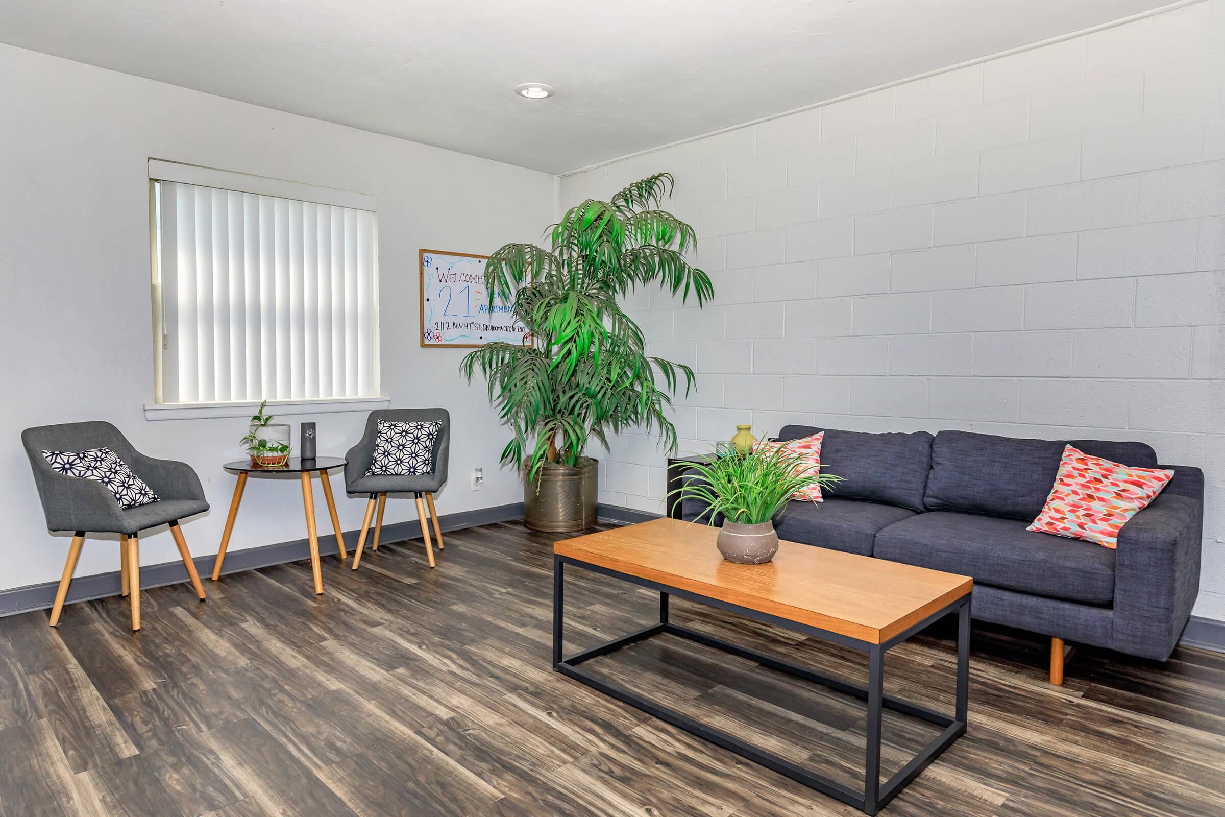 a living room filled with furniture and a large window