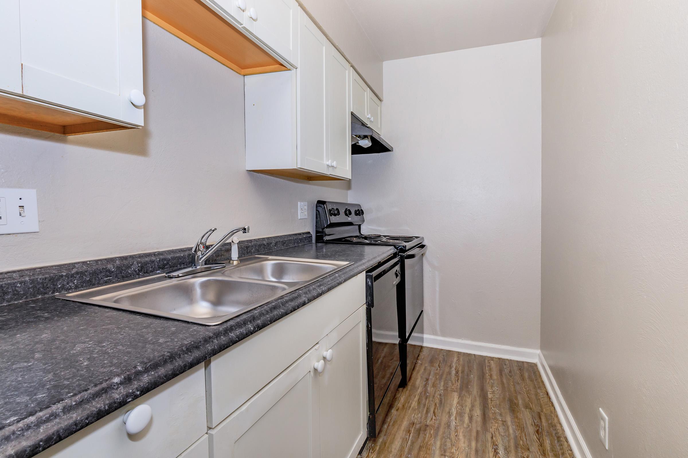 a kitchen with a stove and a sink