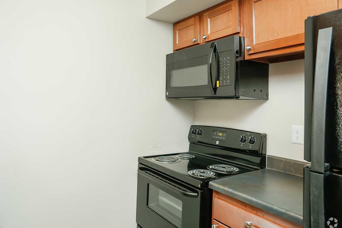 a stove top oven sitting inside of a kitchen