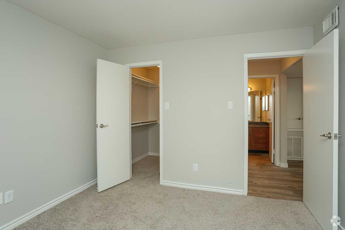 a large empty room with a sink and a mirror