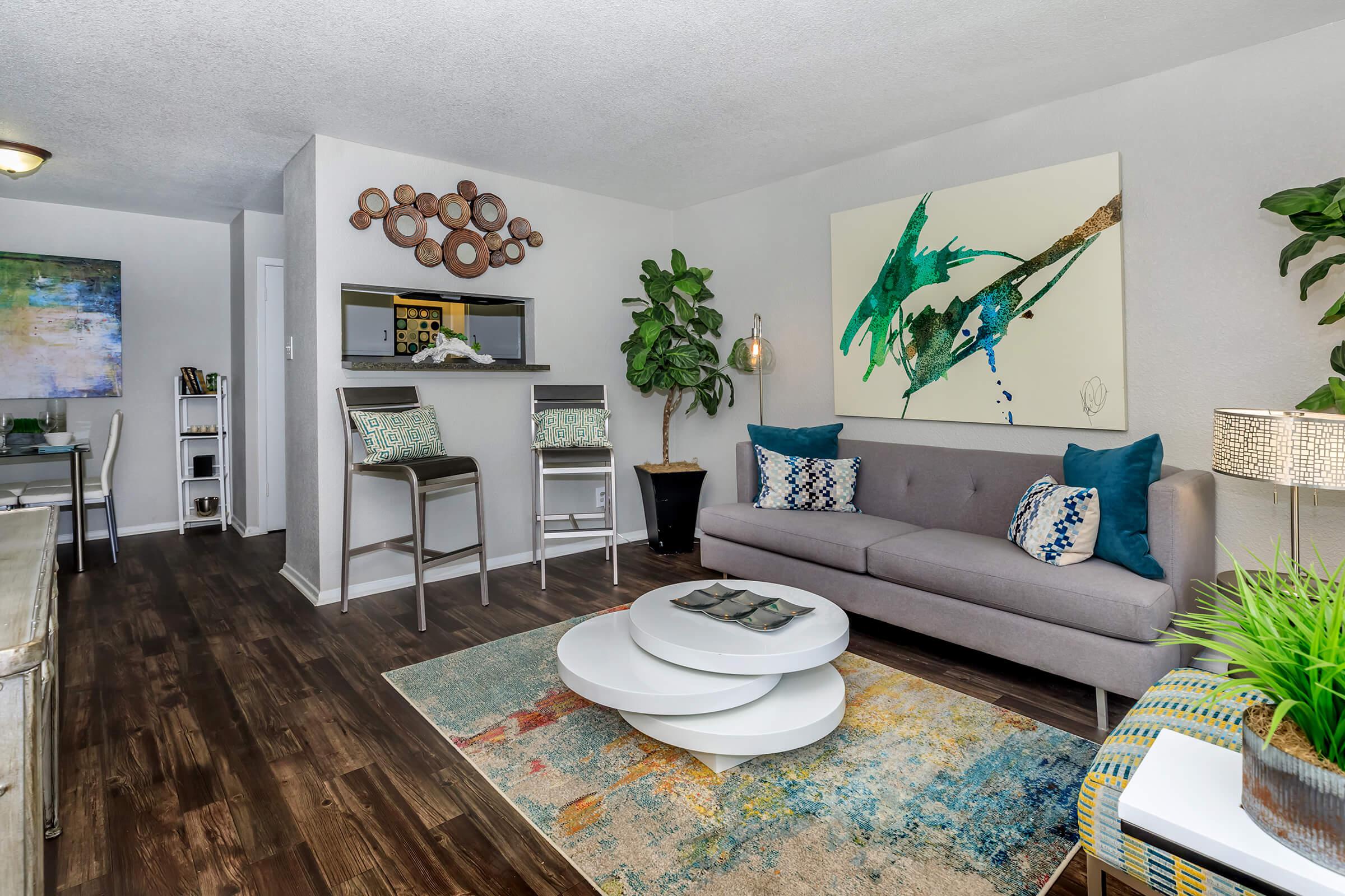 a living room filled with furniture and a flat screen tv