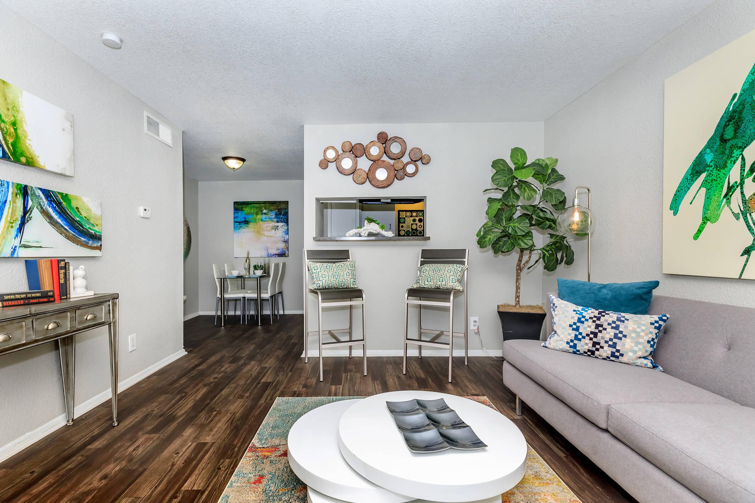 a living room filled with furniture and a flat screen tv