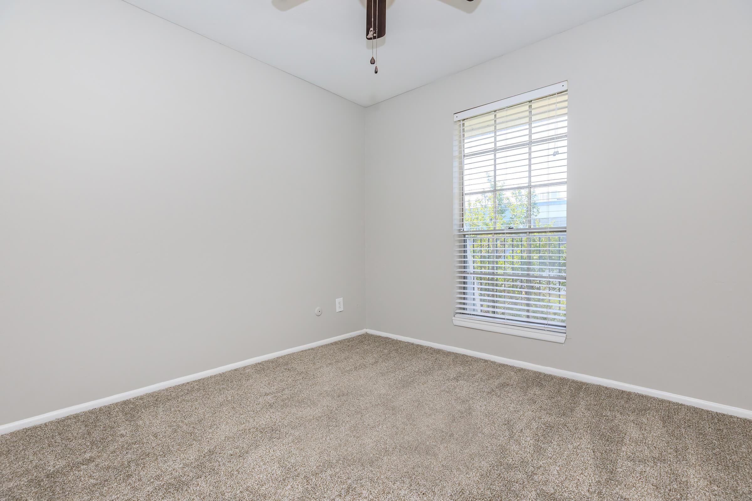 a bedroom with a large window