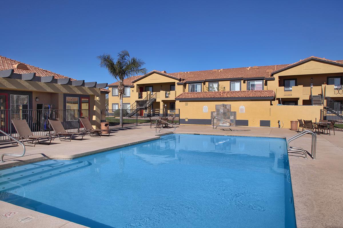 a house with a pool in front of a building