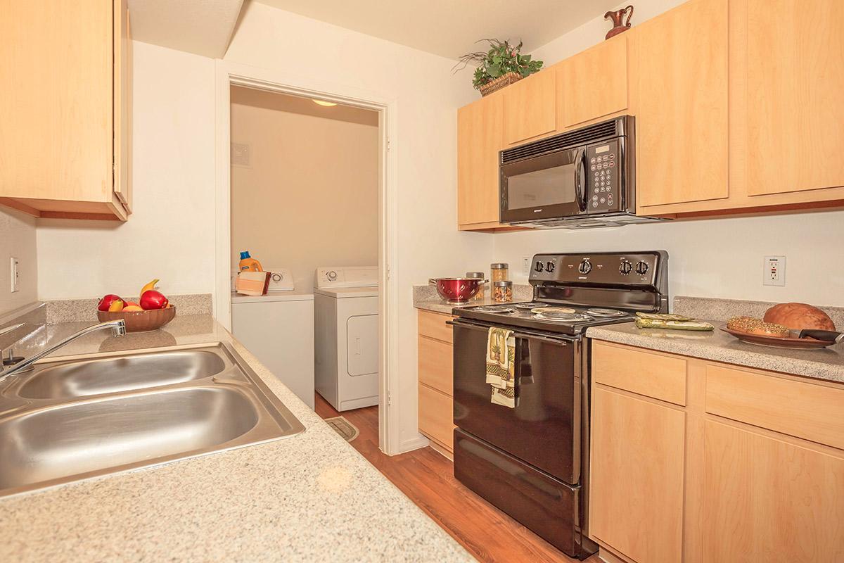 a kitchen with a stove sink and refrigerator