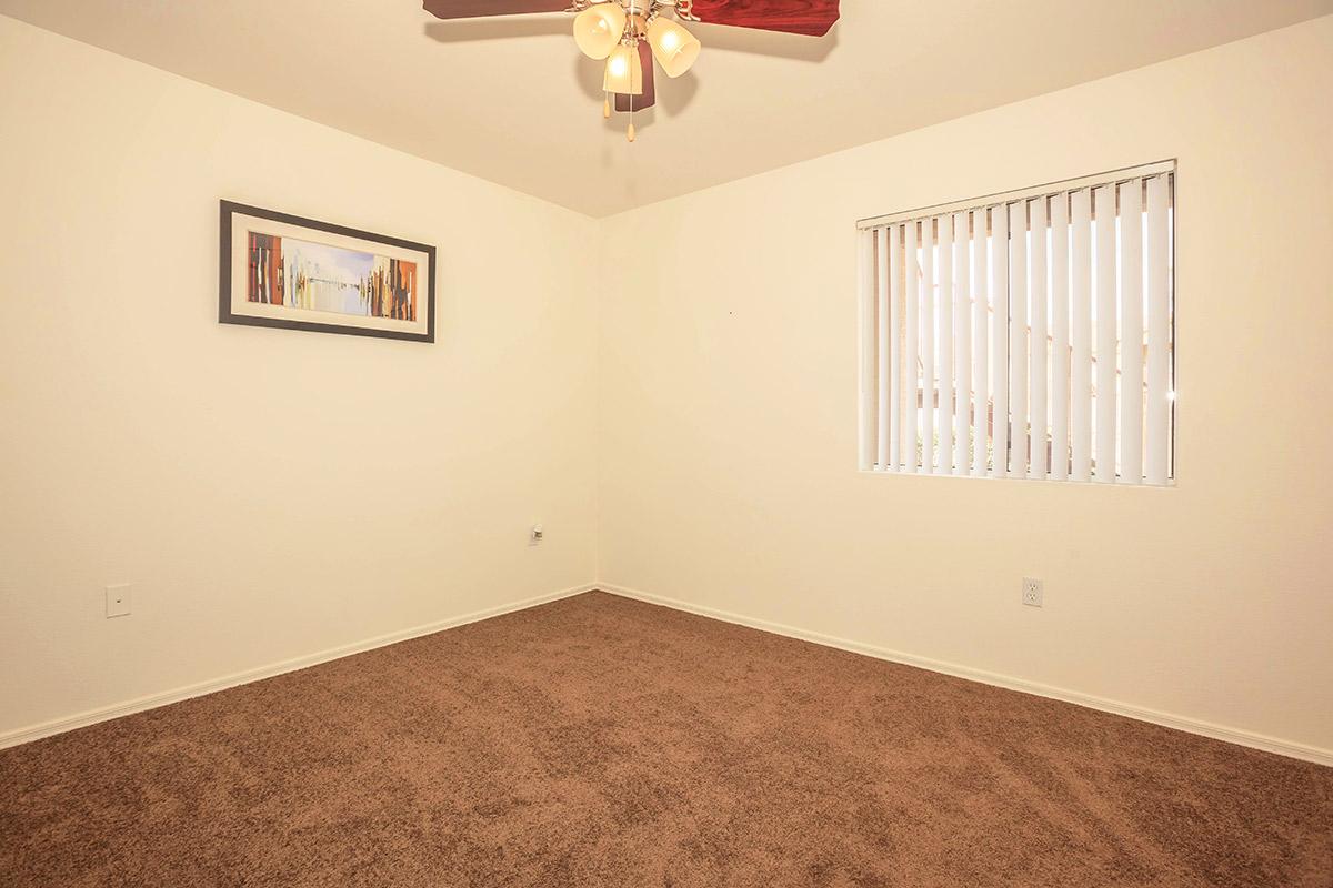 a bedroom with a bed and a mirror