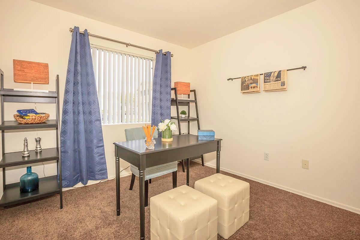 a bedroom with a bed and desk in a small room