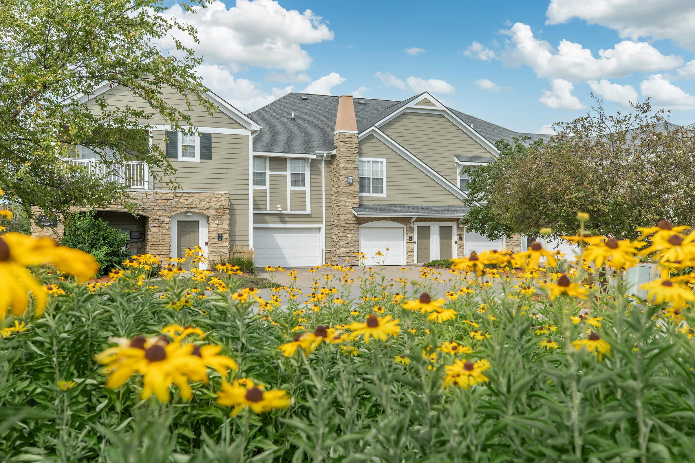 a close up of a flower garden in front of a building