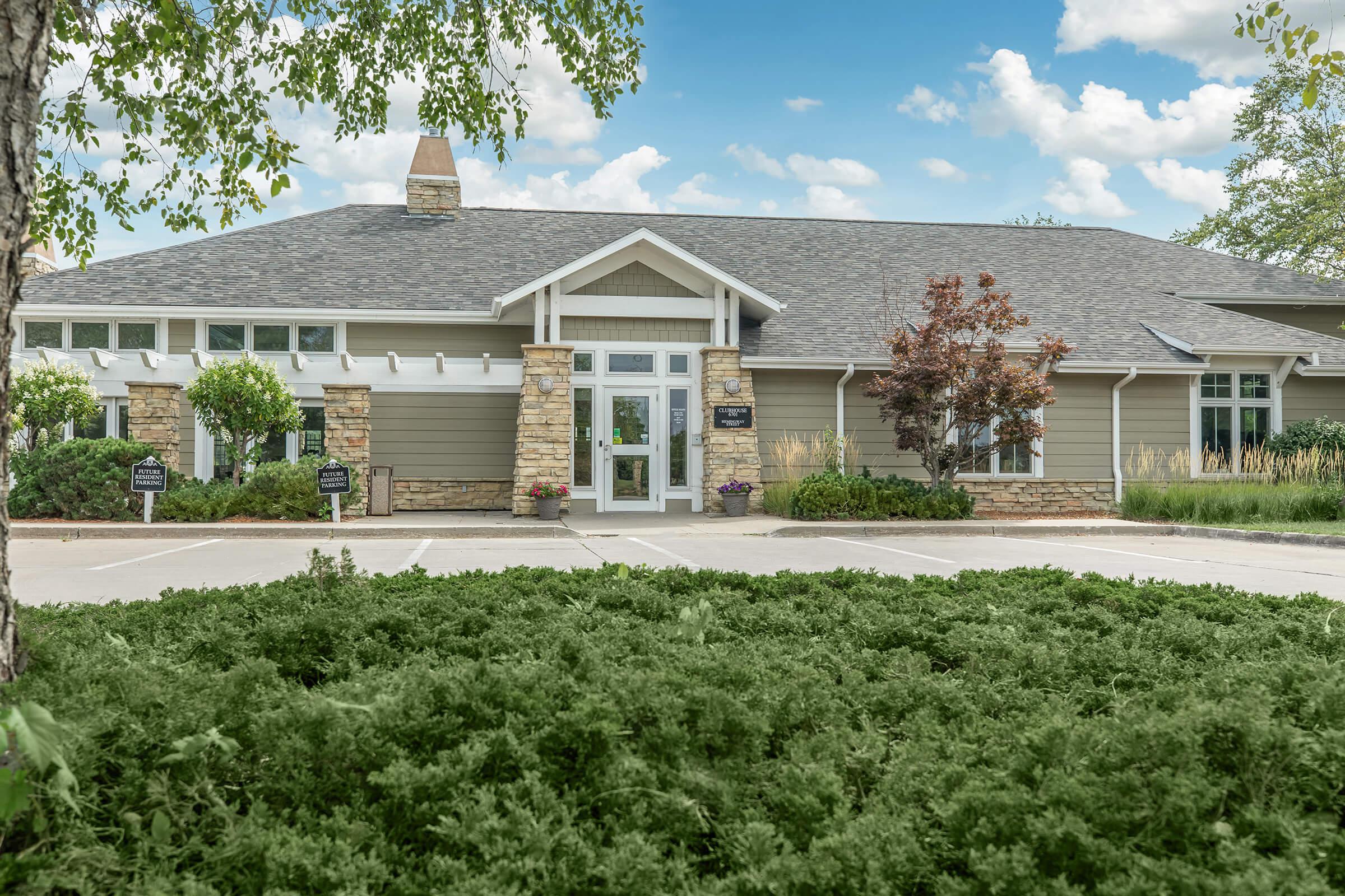 a house with bushes in front of a building