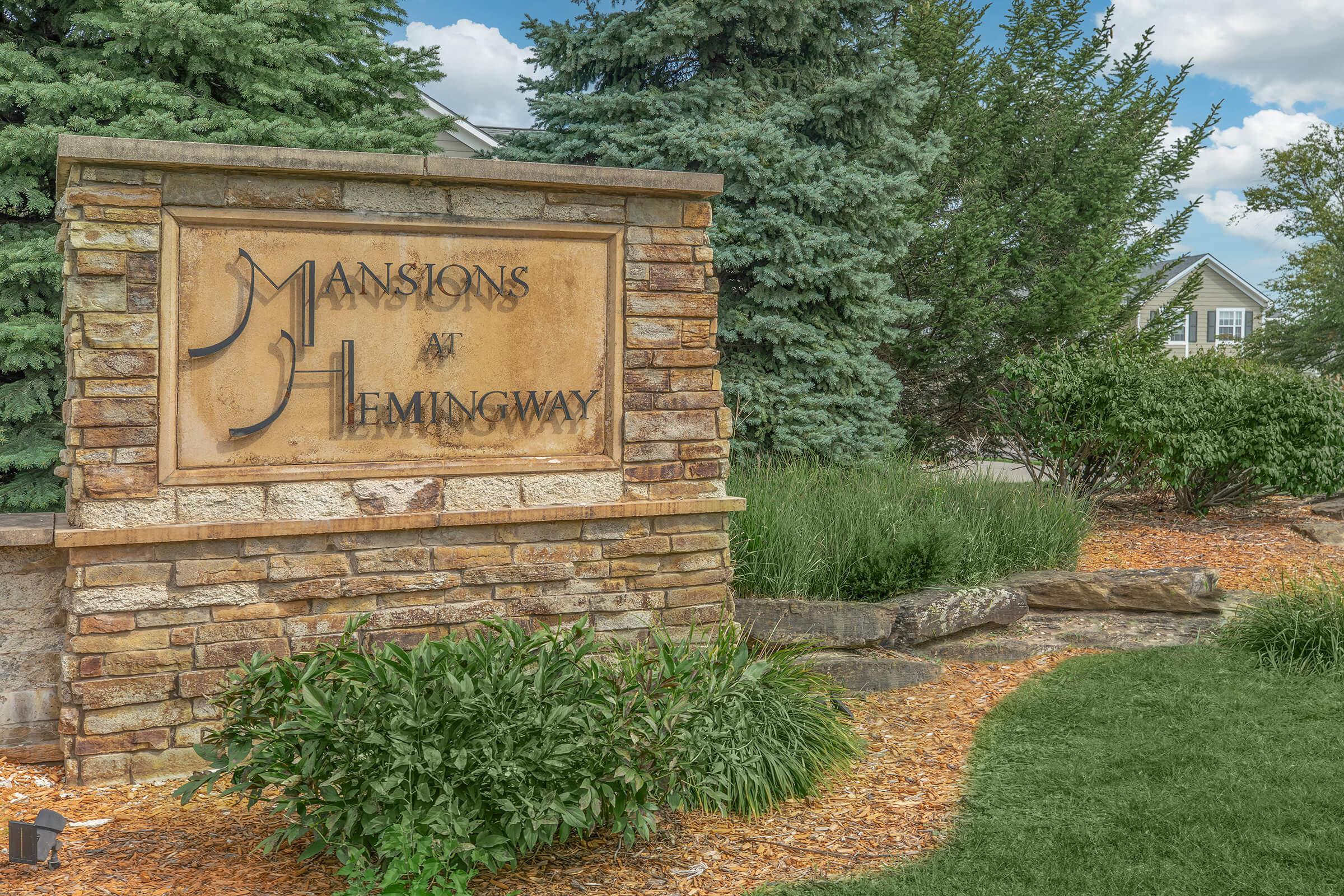 a sign in front of a brick building