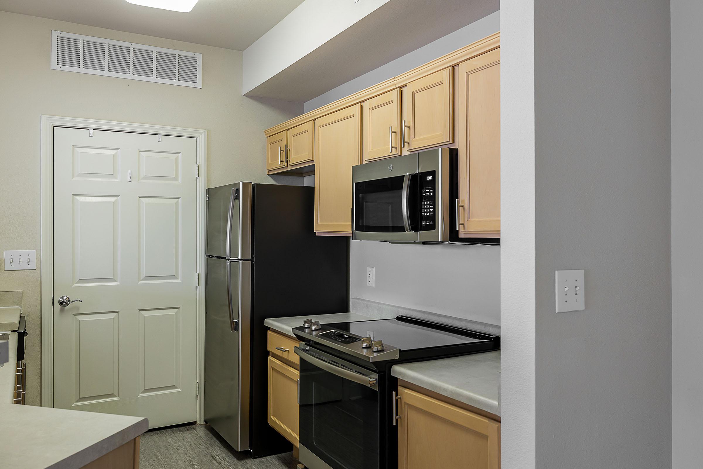 a kitchen with a sink and a refrigerator