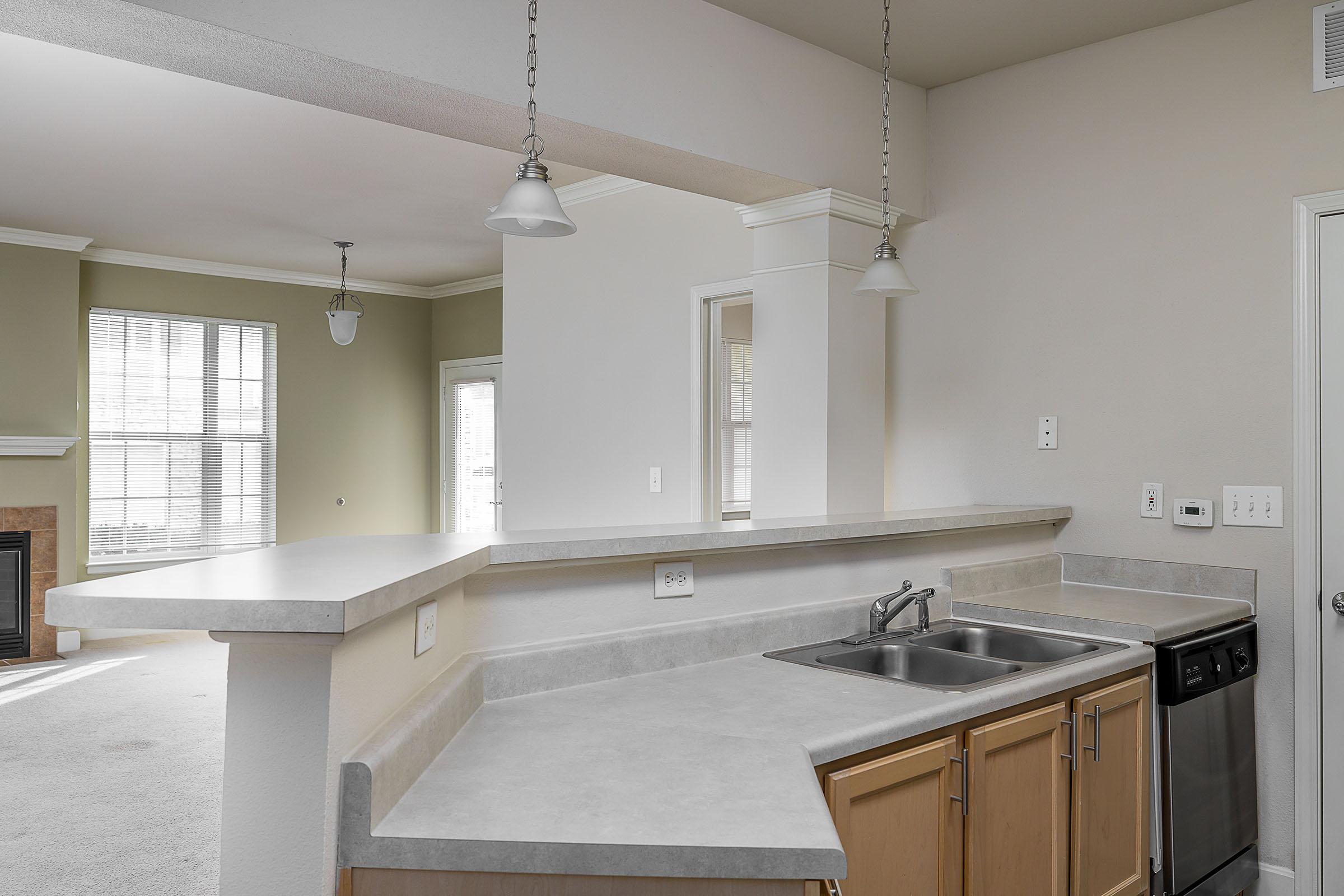 a kitchen with a sink and a mirror