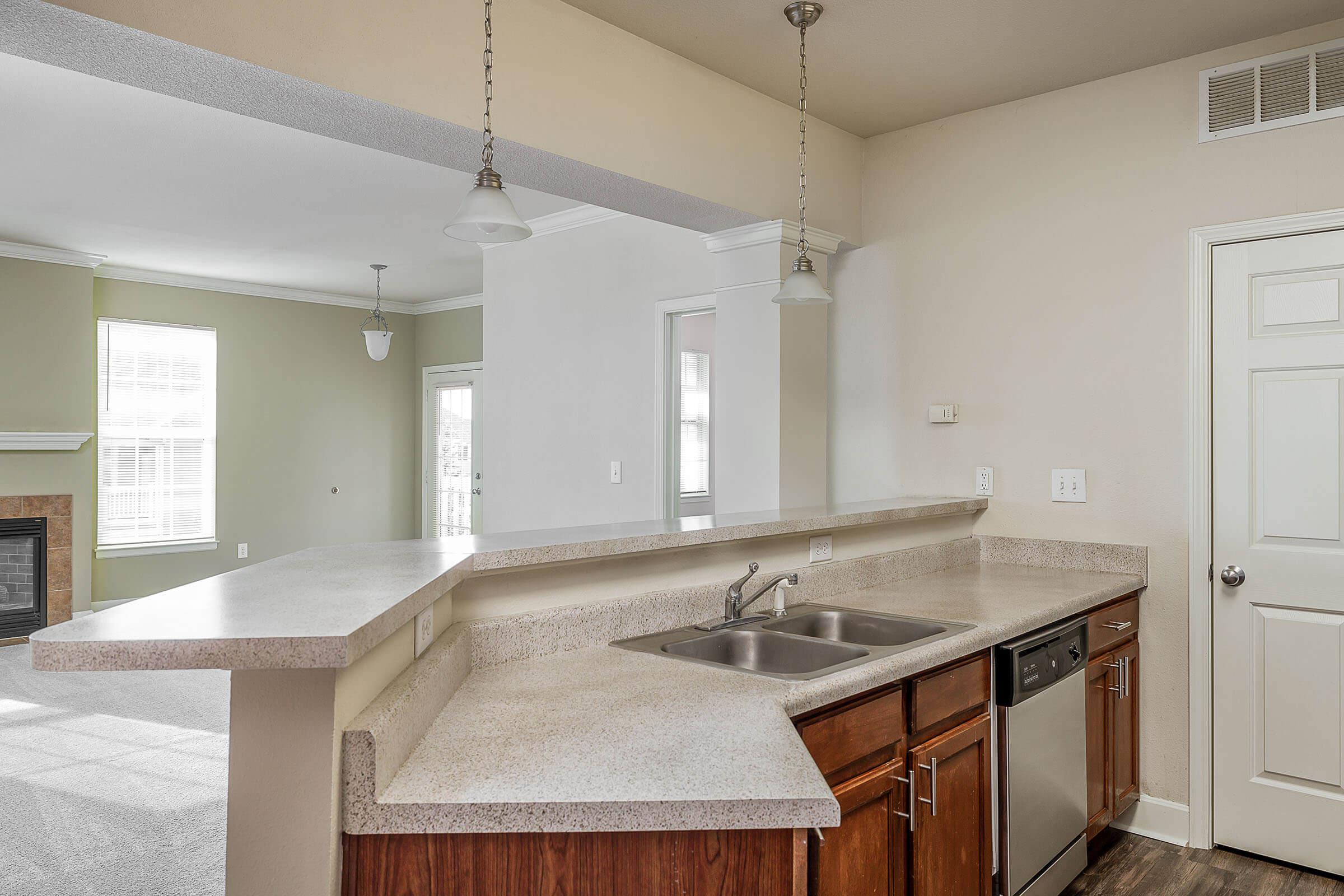 a kitchen with a sink and a mirror