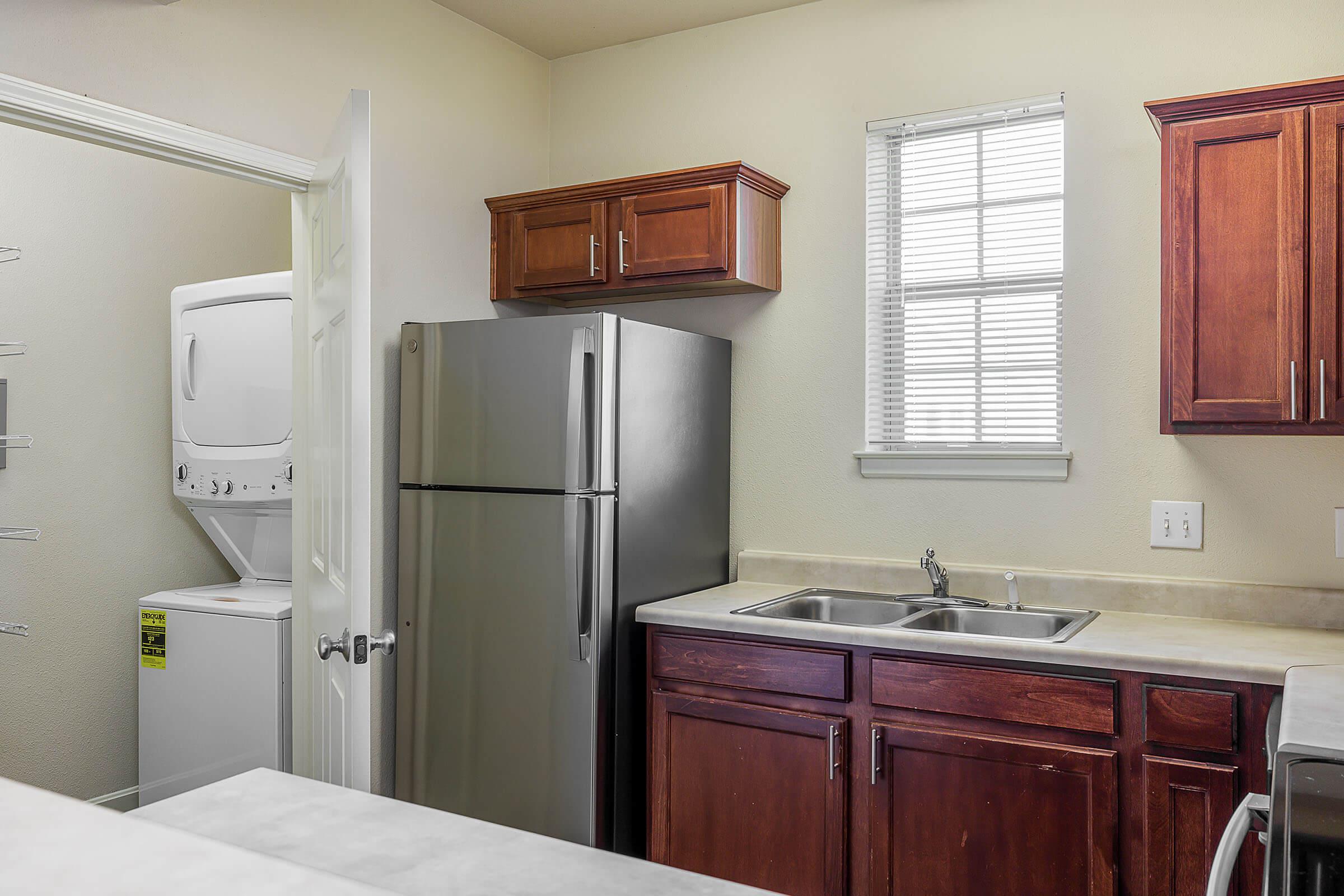 a kitchen with a sink and a refrigerator