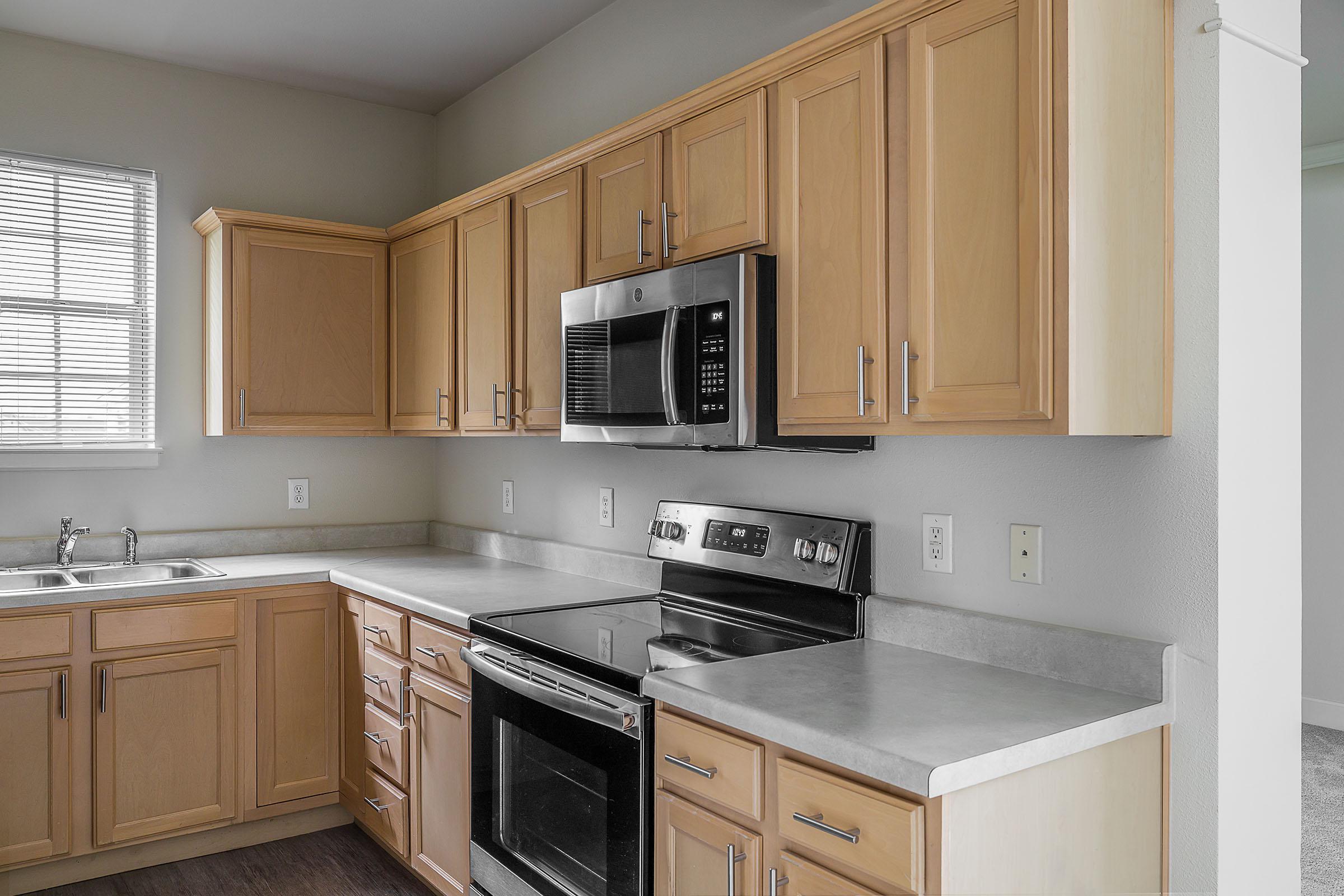 a kitchen with a stove a sink and a microwave