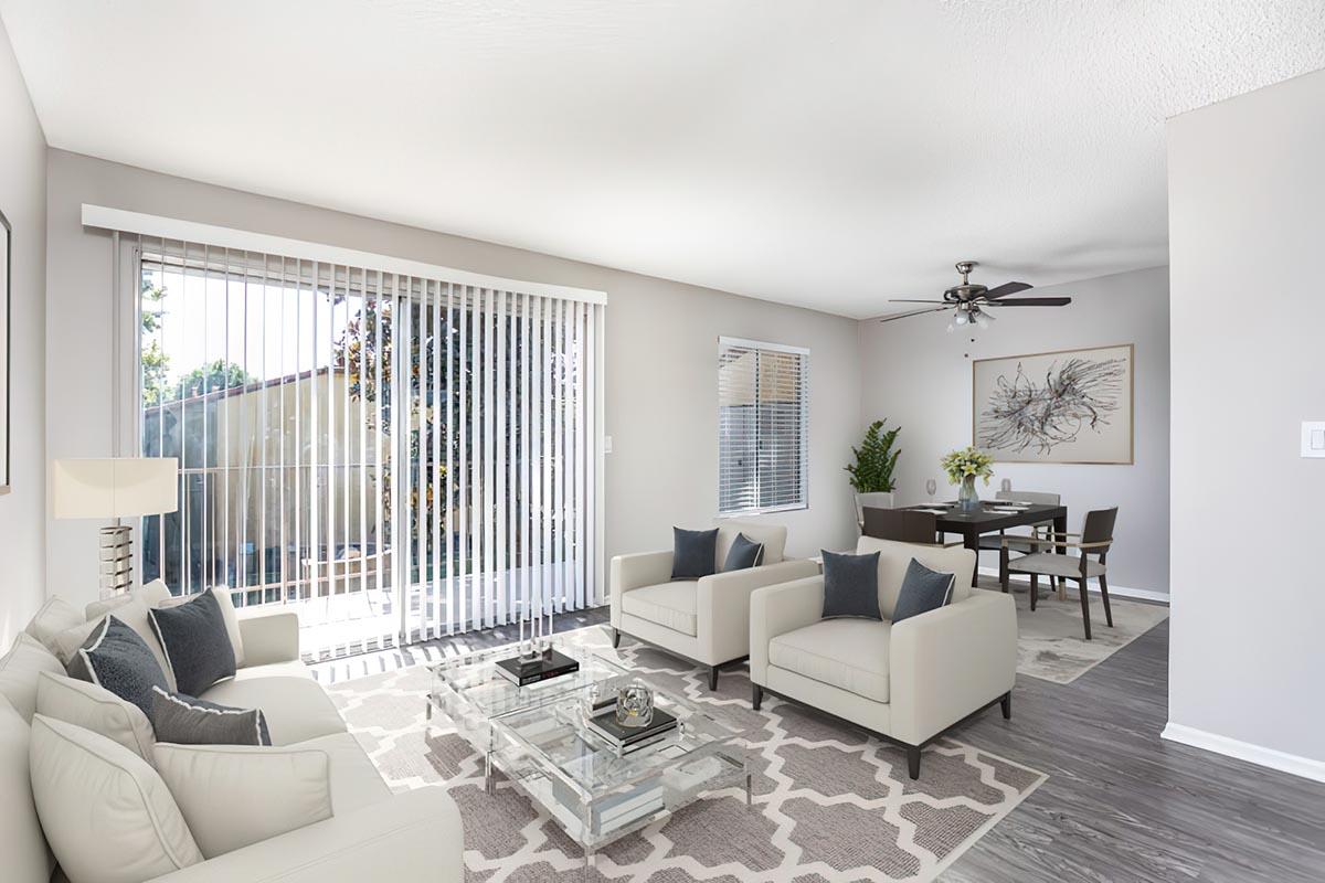 a living room filled with furniture and a large window