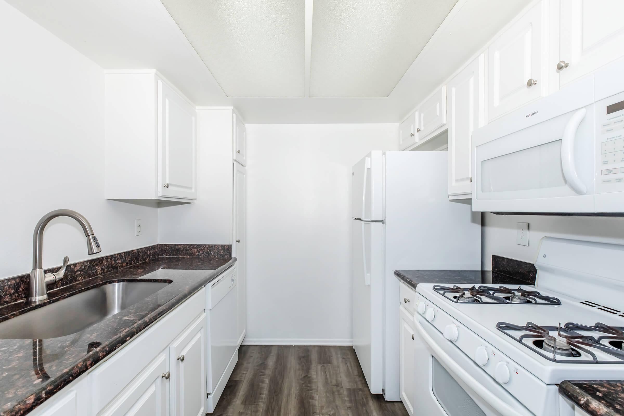 a kitchen with a sink and a refrigerator