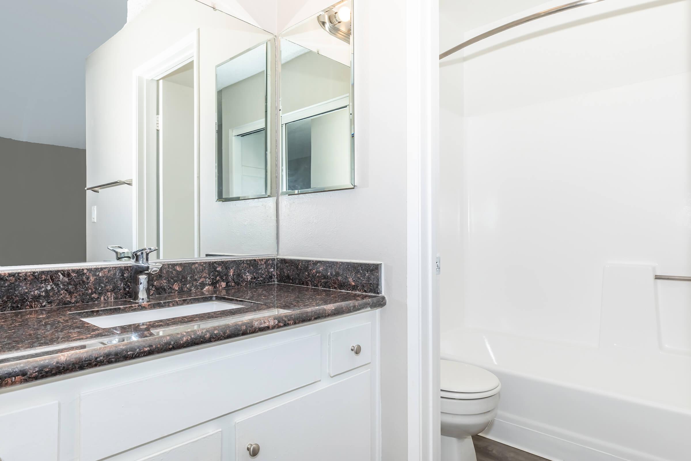 a kitchen with a sink and a mirror