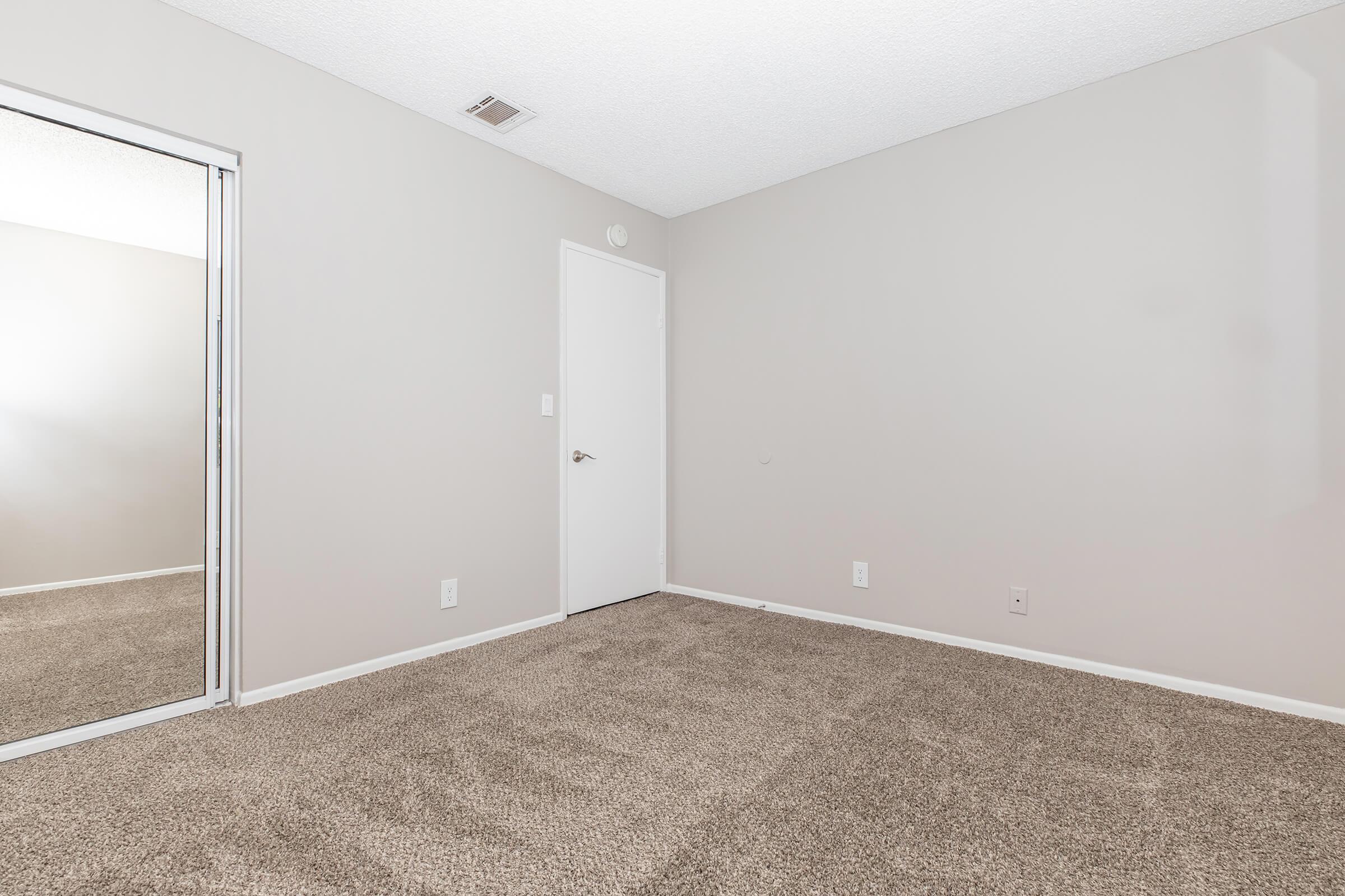 a bedroom with a large mirror