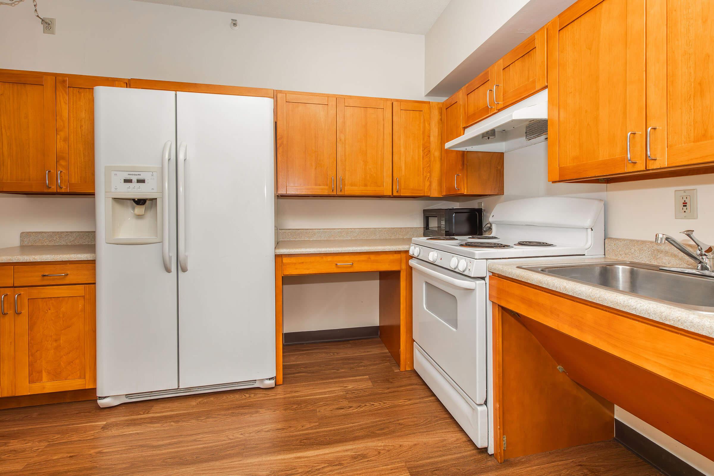 a kitchen with a stove and a refrigerator