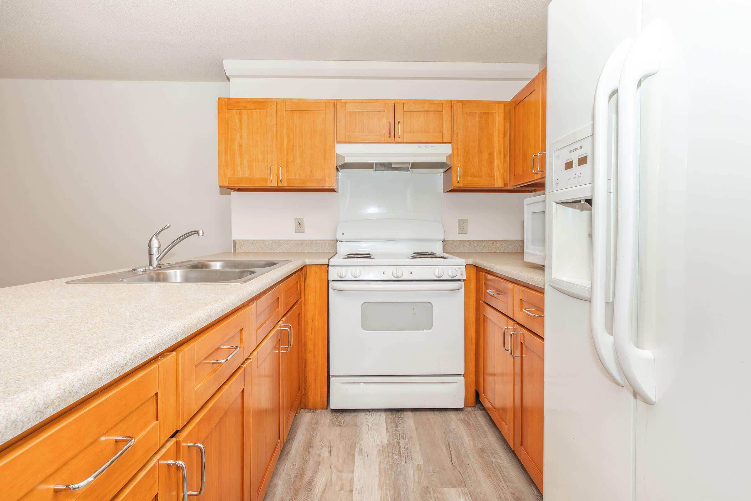 a kitchen with a stove and a refrigerator