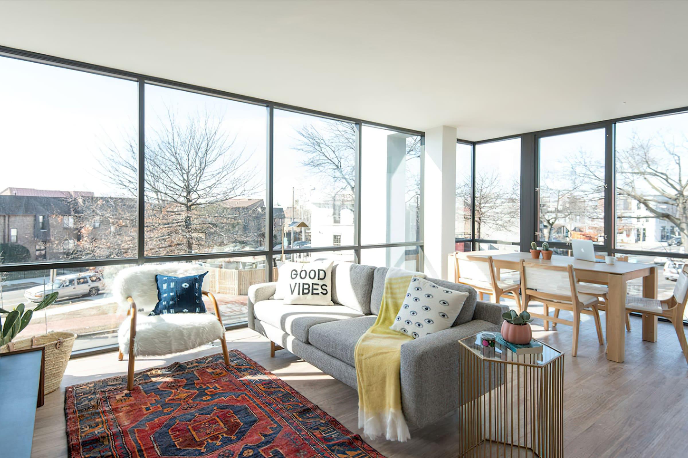 a living room filled with furniture and a large window